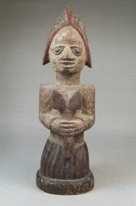 Figure of a Devotee of Shango Holding an Oshe Shango - Brooklyn Museum